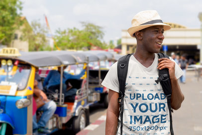 T-Shirt Mockup of a Man Doing a Tour Through a City