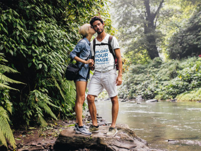 V-Neck T-Shirt Mockup Featuring a Couple Hiking by a River 