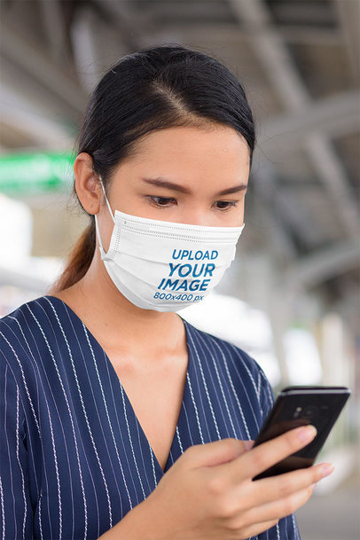 Sublimated Face Mask Mockup of a Woman Checking Her Mobile Phone
