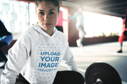 Heathered Hoodie Mockup of a Woman Training with a Barbell