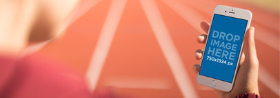 Runner Looking At His White iPhone 6 While On A Speed Track Mockup a14100wide