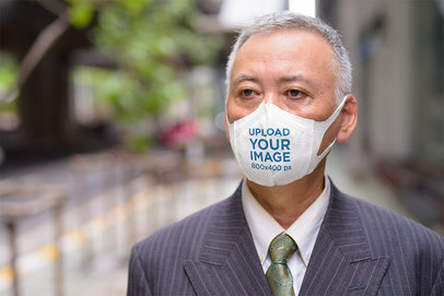 Face Mask Mockup of an Elderly Man Wearing a Formal Suit