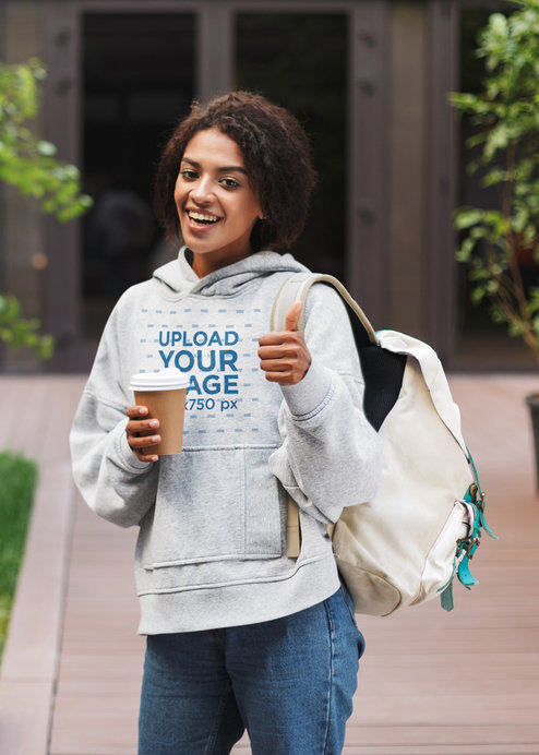 Heather Hoodie Mockup of a Young Student Doing a Thumbs Up Sign