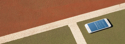 Mockup Of White iPhone 6 Lying On A Tennis Court a14096wide