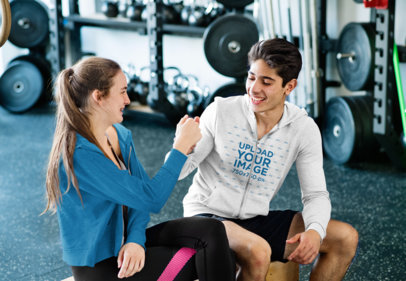 Mockup of a Teenage Boy Wearing a Full-Zip Hoodie at the Gym