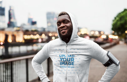 Full-Zip Hoodie Mockup of a Man Jogging in the City