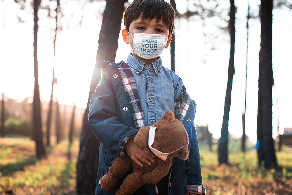 Face Mask Mockup of a Boy Holding His Teddy Bear