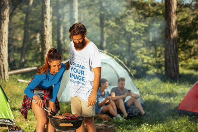 T-Shirt Mockup of a Man Camping with a Group of Friends