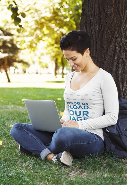 Long Sleeve Tee Mockup of a Woman on Her Laptop at a Park