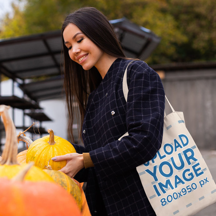 Grocery Bag Mockup Featuring a Happy Woman Buying a Pumpkin 
