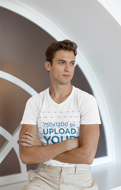 V-Neck T-Shirt Mockup of a Young Man Posing With His Arms Crossed 
