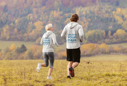 Heather Hoodie Mockup of a Man and a Woman Running at the Outdoors