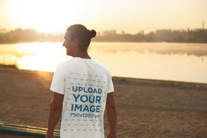 Mockup of the Back of a Man Wearing a T-Shirt While Watching the Sunset