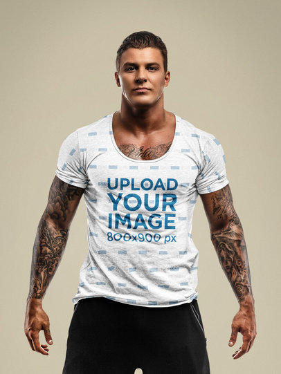 Mockup of a Muscular Man with Tattoos Wearing a Sublimated T-Shirt