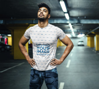 Sublimated T-Shirt Mockup Featuring a Man at a Parking Lot