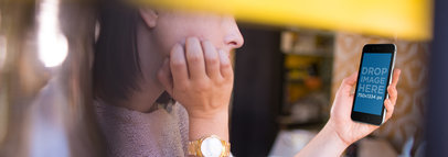 Mockup of a Wooman Using an iPhone at a Coffee Shop 14003w