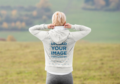 Back-View Hoodie Mockup of a Woman Standing Outdoors