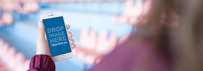 Mockup Of A Woman Using Her White iPhone 6 While At A Red And Blue Stadium