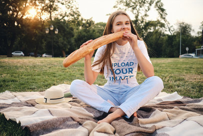 T-Shirt Mockup of a Young Woman Eating a Baguette 