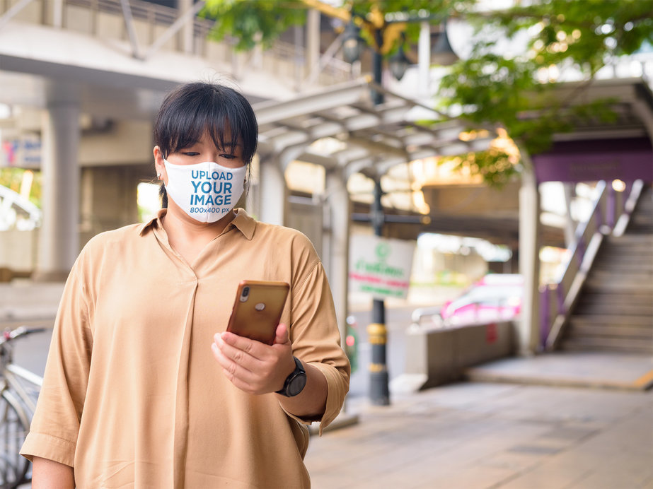 Face Macl Mockup of a Woman Checking Up Her Phone in the Street