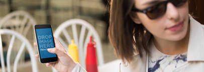 iPhone 6 Being Held By Woman With Sunglasses At A Diner Restaurant Mockup