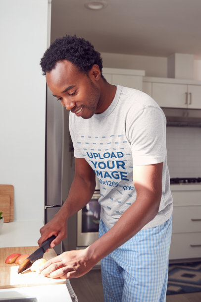 T-Shirt Mockup of a Man Cutting Some Vegetables