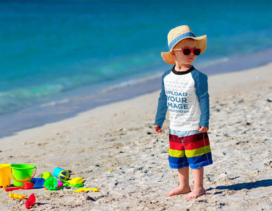 Raglan Long Sleeve Tee Mockup Featuring a Serious Kid With Sunglasses at the Beach