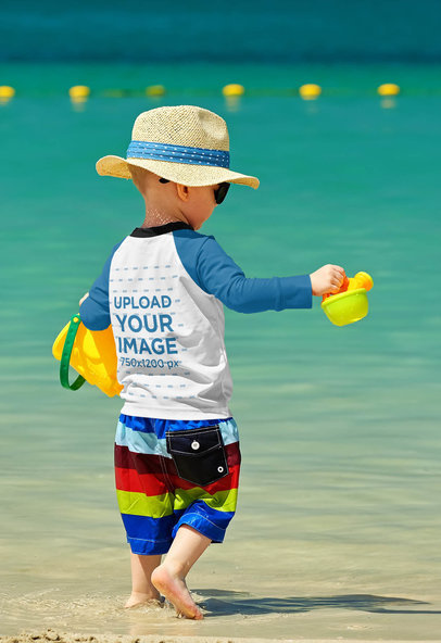 Mockup of a Toddler Wearing a Raglan Long Sleeve Tee by the Beach 42124-r-el2