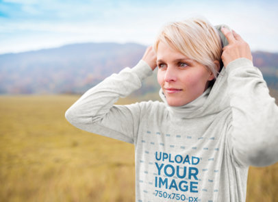 Mockup of a Woman Using a Pullover Hoodie Outdoors