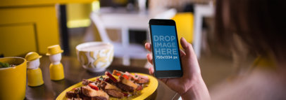 Mockup Of A Woman Holding An iPhone 6 On Her Right Hand While About To Have Breakfast