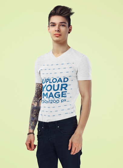 Mockup of a Tattooed Young Man Wearing a V-Neck T-Shirt at a Studio