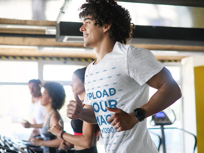 Mockup of a Man with a Heather Activewear Tee Running on a Treadmill 