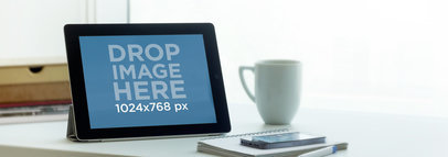 Wide Mockup of an iPad in Landscape Position Next to a Window