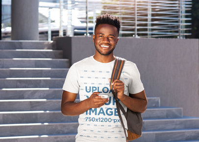 Mockup of a Man with a Basic Tee Posing Outside of College 