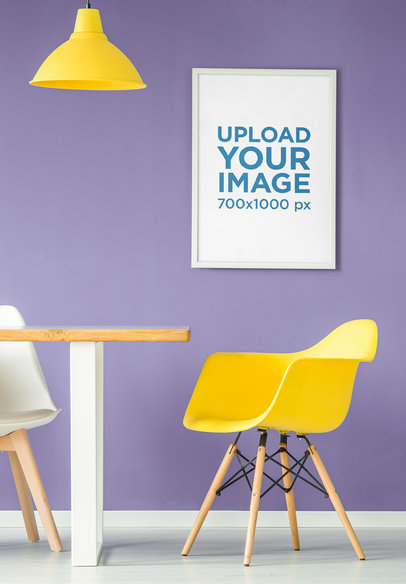 Mockup of an Art Print Hanging by a Minimalist Chair