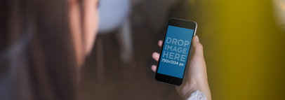 Over Shoulder Template Of A Pretty Young Girl Using Her Black iPhone 6 While At A Coffee Shop a14005wide