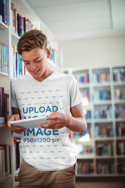 Mockup of a Teenager with a Heathered V-Neck T-Shirt Using a Device at the Library