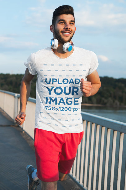T-Shirt Mockup Featuring a Young Man Running Outdoors