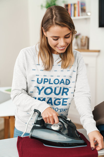 Sweatshirt Mockup Featuring a Woman Ironing 