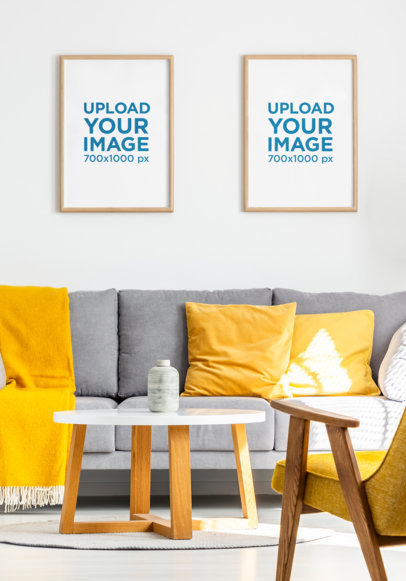 Mockup of Two Art Prints Hanging Over a Comfy Couch 
