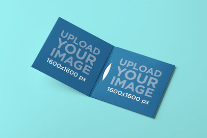 Mockup of an Open Digipak Placed on a Plain-Colored Surface