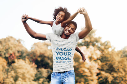 T-Shirt Mockup of a Man Playing with His Daughter in Nature