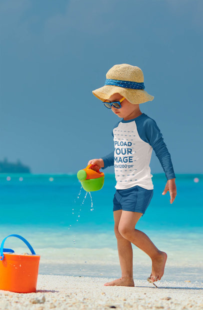 Raglan Long Sleeve Tee Mockup Featuring a Kid Playing at a Tropical Beach