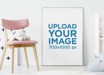 Mockup of an Art Print Leaning over a Wall Next to a Baby's Teddies