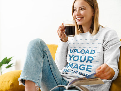 Heathered Sweatshirt Mockup of a Woman Drinking a Coffee at Home