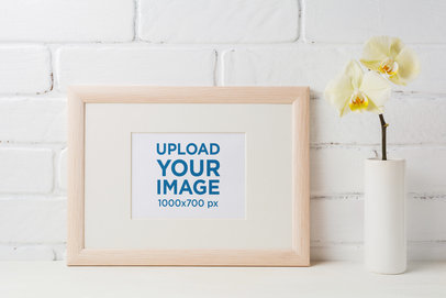 Mockup of an Art Print Placed Next to a Small Flower Vase 
