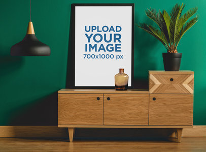 Mockup Featuring a Framed Art Print Placed Against a Green Wall 