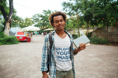 Heathered V-Neck Tee Mockup Featuring a Man Holding School Supplies 
