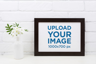 Mockup of a Horizontal Art Print Placed by a Flower Vase 