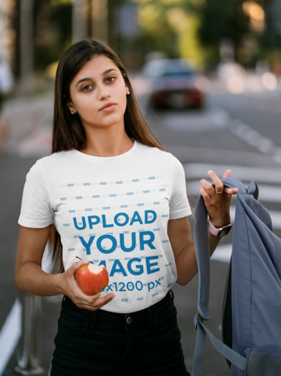 T-Shirt Mockup of a Female Student Holding a Bitten Apple 41402-r-el2